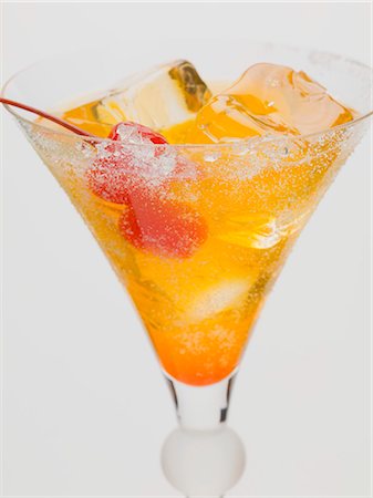 Tequila Sunrise with ice cubes and cocktail cherries Stock Photo - Premium Royalty-Free, Code: 659-03529584