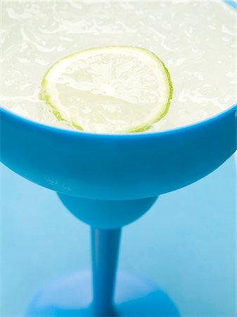 simsearch:659-01858652,k - Frozen Margarita with slice of lime in blue glass Stock Photo - Premium Royalty-Free, Code: 659-03529629