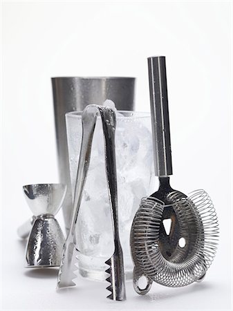 Various bar utensils and glass filled with ice cubes Stock Photo - Premium Royalty-Free, Code: 659-03529685