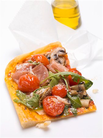 simsearch:659-03529700,k - Slice of pizza topped with ham, tomatoes, mushrooms, rocket Stock Photo - Premium Royalty-Free, Code: 659-03529699