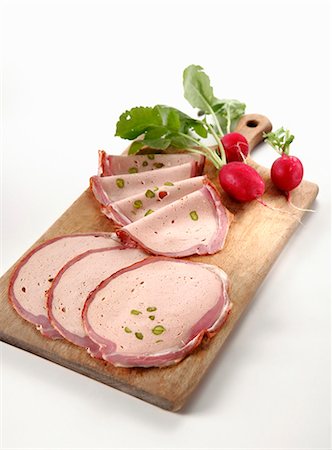 Several slices of breast of veal & radishes on chopping board Stock Photo - Premium Royalty-Free, Code: 659-03529707