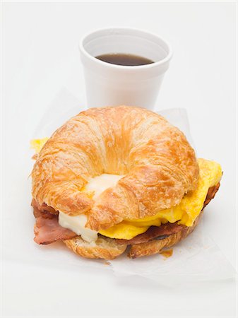 scrambled - Croissant with bacon, scrambled egg & cheese, cup of coffee Stock Photo - Premium Royalty-Free, Code: 659-03529735