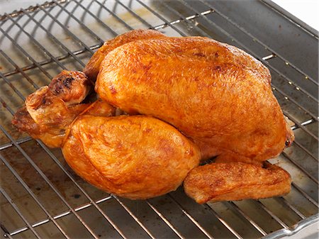 Whole roast chicken on rack Fotografie stock - Premium Royalty-Free, Codice: 659-03529840