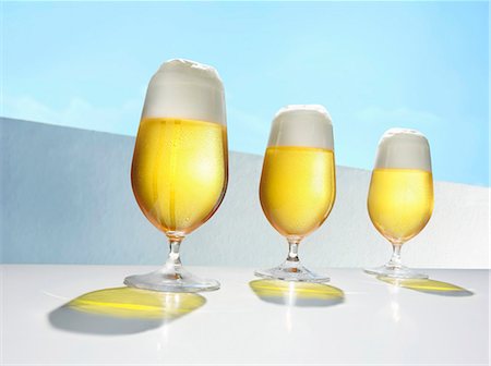Three glasses of beer in a row Stock Photo - Premium Royalty-Free, Code: 659-03529888