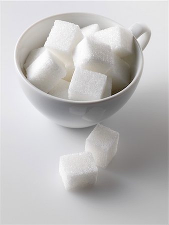 Sugar cubes in and beside white cup Stock Photo - Premium Royalty-Free, Code: 659-03520984