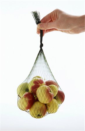 string bag - Apples (variety: Lady) in a net Stock Photo - Premium Royalty-Free, Code: 659-03521048