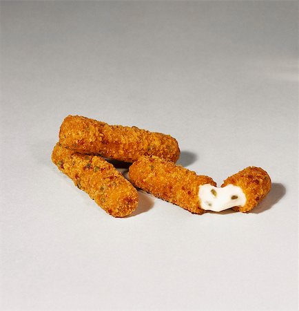 Three Mozzarella Sticks; One Halved Stock Photo - Premium Royalty-Free, Code: 659-03521059