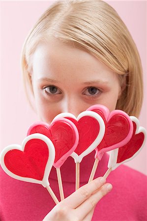 reddy - Young woman with several heart-shaped lollipops Stock Photo - Premium Royalty-Free, Code: 659-03521768