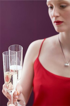 simsearch:659-06671369,k - Young woman clinking a glass of sparkling wine Stock Photo - Premium Royalty-Free, Code: 659-03521773