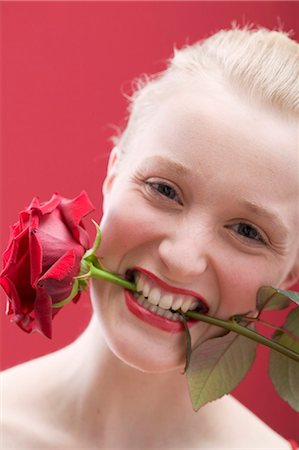 face with rose - Young woman with a red rose in her mouth Stock Photo - Premium Royalty-Free, Code: 659-03521780