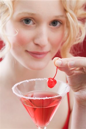 red cocktail - Young woman with Cosmopolitan Stock Photo - Premium Royalty-Free, Code: 659-03521797