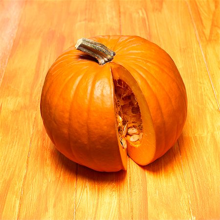 pumpkin seed - An orange pumpkin with a piece removed Stock Photo - Premium Royalty-Free, Code: 659-03521878