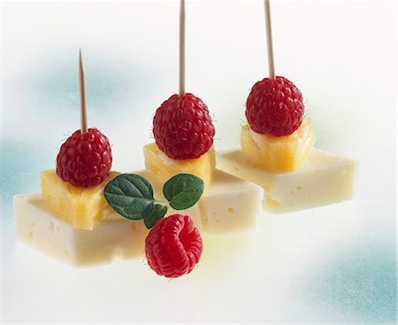 Cheese, pineapple and raspberries on cocktail sticks Stock Photo - Premium Royalty-Free, Code: 659-03522151