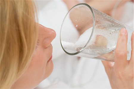 Woman drinking a glass of mineral water Stock Photo - Premium Royalty-Free, Code: 659-03522507