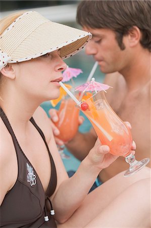 simsearch:659-03535770,k - Man and woman drinking Planter's Punch by pool Stock Photo - Premium Royalty-Free, Code: 659-03522555