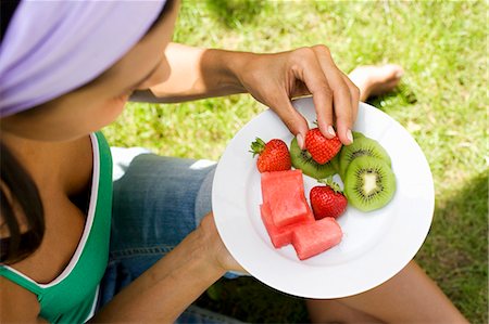 sitting aerial view - Young woman with plate of fruit Stock Photo - Premium Royalty-Free, Code: 659-03522655