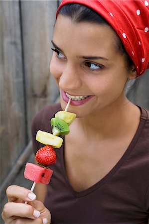 decollete - Young woman with fruit skewer Stock Photo - Premium Royalty-Free, Code: 659-03522659