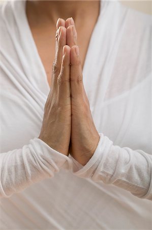 Young woman meditating with hands together Stock Photo - Premium Royalty-Free, Code: 659-03523397