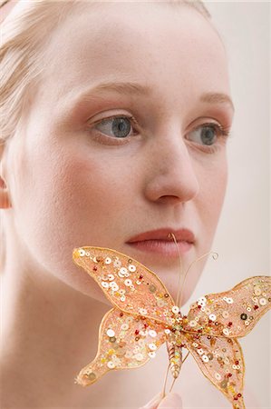 fake butterflies - Young blond woman with an artificial butterfly Stock Photo - Premium Royalty-Free, Code: 659-03523417