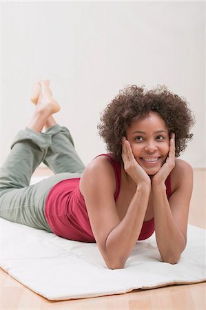 Young woman lying on a mat Stock Photo - Premium Royalty-Free, Code: 659-03523420