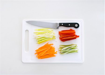 Julienne vegetables on a chopping board with a knife Stock Photo - Premium Royalty-Free, Code: 659-03523606