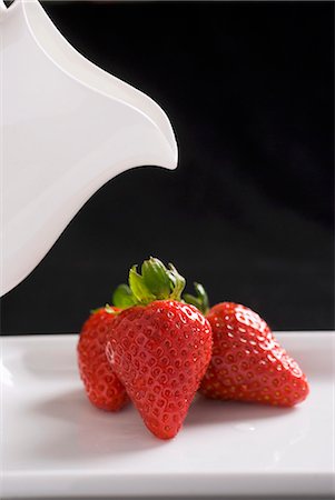simsearch:659-01866279,k - Three fresh strawberries with a cream jug Stock Photo - Premium Royalty-Free, Code: 659-03523730