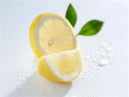 Slice and wedge of lemon Stock Photo - Premium Royalty-Free, Code: 659-03534102