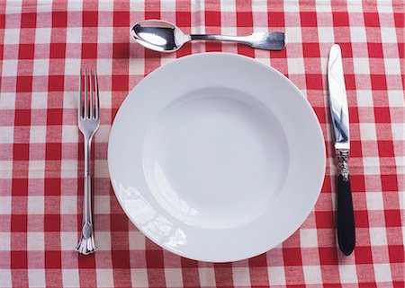 setting table flatware - Plate, knife, fork and spoon on checked tablecloth Stock Photo - Premium Royalty-Free, Code: 659-03534445