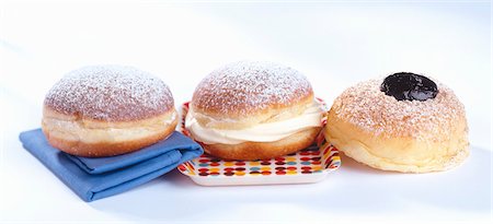Three doughnuts with plum jelly, vanilla cream and jam Stock Photo - Premium Royalty-Free, Code: 659-03534443