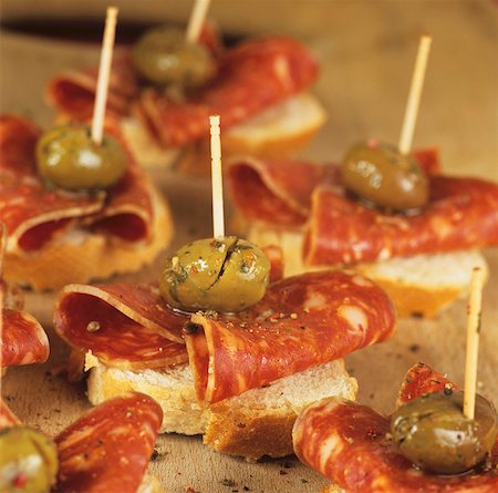 spain dish - Canapés with chorizo and green olives Stock Photo - Premium Royalty-Free, Code: 659-03534565