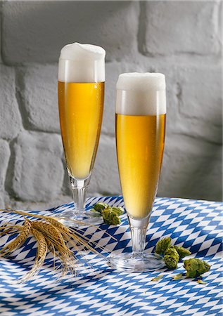 different glasses beer - Two glasses of pils on blue and white tablecloth Stock Photo - Premium Royalty-Free, Code: 659-03534582