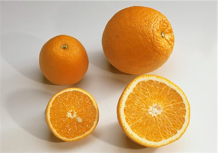 Oranges, whole and halved Stock Photo - Premium Royalty-Free, Code: 659-03534650