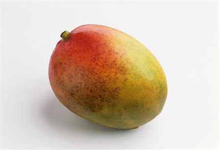 A mango against a white background Foto de stock - Sin royalties Premium, Código: 659-03534675