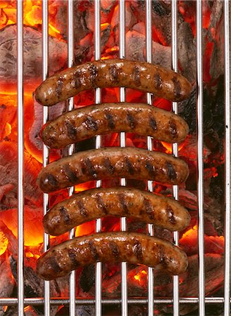 simsearch:659-03524106,k - Five sausages on barbecue rack over burning charcoal Foto de stock - Sin royalties Premium, Código: 659-03534758