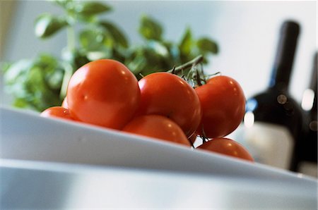 simsearch:659-06307183,k - Tomatoes on kitchen table, basil and wine in background Foto de stock - Royalty Free Premium, Número: 659-03534751