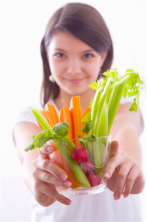 Girl holding a bowl of vegetable sticks with radishes Stock Photo - Premium Royalty-Free, Code: 659-03534790