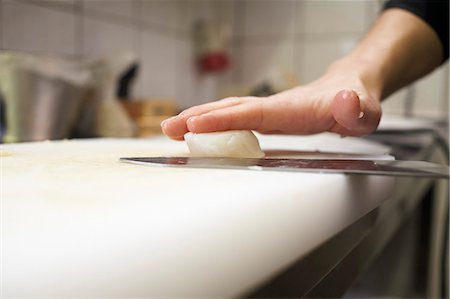 restaurant kitchen - Cutting a scallop in half Stock Photo - Premium Royalty-Free, Code: 659-03535240