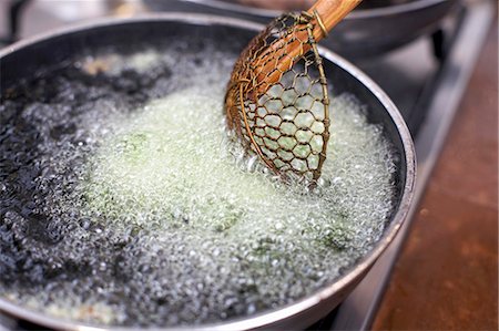 deep fry - Fat bubbling in a frying pan Stock Photo - Premium Royalty-Free, Code: 659-03535253