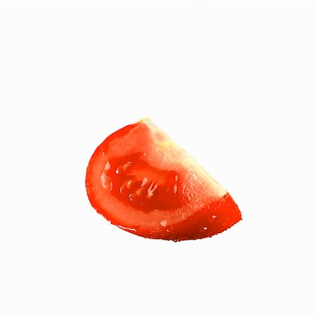 A tomato wedge with drops of water Stock Photo - Premium Royalty-Free, Code: 659-03535373