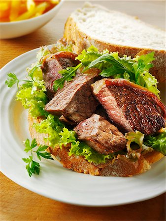 simsearch:659-03530038,k - Beef steak with leaf salad on white bread Stock Photo - Premium Royalty-Free, Code: 659-03535546