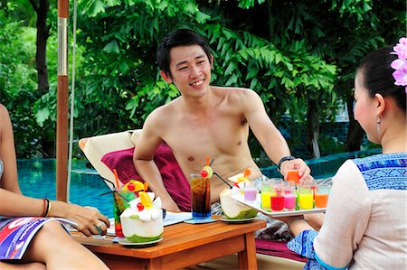 simsearch:659-03535770,k - Woman serving cold, exotic fruit drinks by pool Stock Photo - Premium Royalty-Free, Code: 659-03535772
