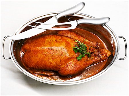 simsearch:659-08419032,k - Roast goose in roasting dish, carving knife and fork Stock Photo - Premium Royalty-Free, Code: 659-03535784