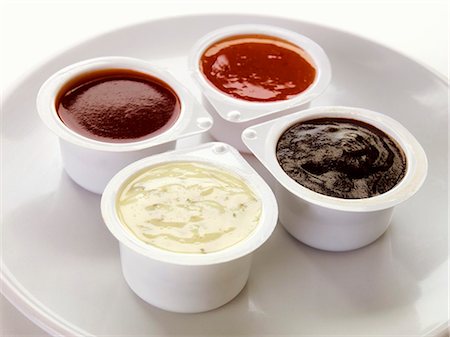 dip selection - Four different dips in plastic pots Stock Photo - Premium Royalty-Free, Code: 659-03536126