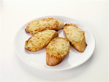 Toasted cheese on baguette slices with garlic Fotografie stock - Premium Royalty-Free, Codice: 659-03536161