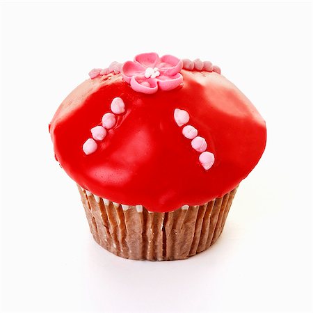 Muffin with red icing and sugar flower Foto de stock - Sin royalties Premium, Código: 659-03536235