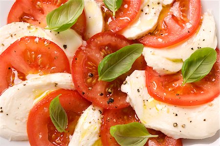 Tomatoes with mozzarella and basil (detail) Stock Photo - Premium Royalty-Free, Code: 659-03536268