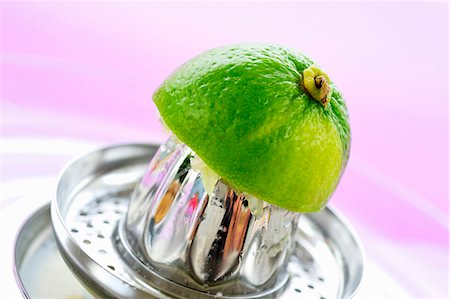 fruit squeezing - Squeezing a lime Stock Photo - Premium Royalty-Free, Code: 659-03536421