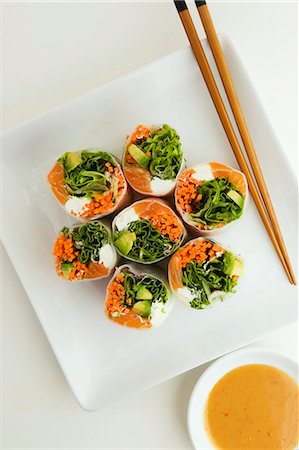 simsearch:659-03537682,k - Salmon Rolls on a Plate with Chopsticks and Peanut Dipping Sauce Stock Photo - Premium Royalty-Free, Code: 659-03536588