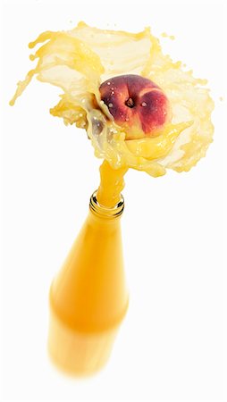 peach (fruit) - Peach juice splashing out of bottle Stock Photo - Premium Royalty-Free, Code: 659-03536748