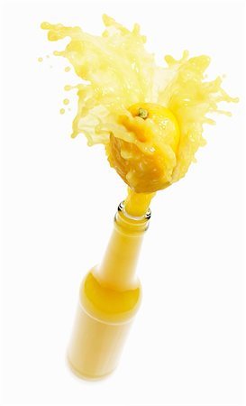 fruit drinks lemon - Lemon juice splashing out of bottle Stock Photo - Premium Royalty-Free, Code: 659-03536764